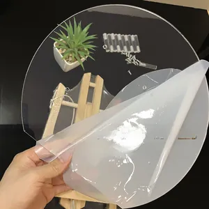 Detailed view of clear acrylic dessert stand components with wood base and screws