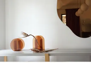 Detail of amber acrylic geometric vases in circular and arched designs for home decor