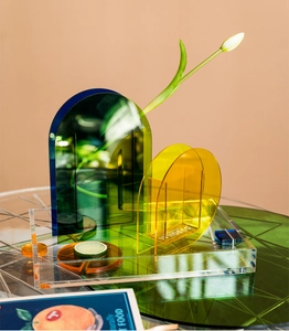 Close-up of geometric acrylic trays and vases with vibrant translucent colors for home decor