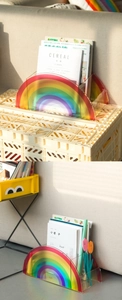Close-up of rainbow acrylic magazine organizer with vibrant gradient arch design