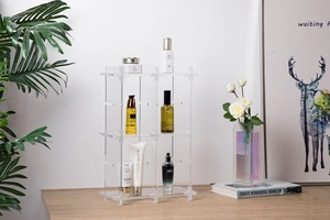 Three-tier transparent acrylic tiered display rack showing modular storage cubes on wood