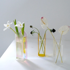 Three modern colorful acrylic vases with minimalist design for home flower decoration