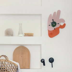 Modern acrylic hand-shaped wall clock in pink and orange minimalist artistic design