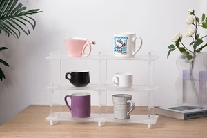 Macro detail of modular 3-tier clear acrylic storage rack for mug organization
