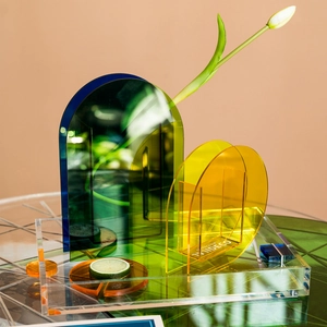Modern acrylic tray set with green arch vase and yellow disc on minimalist brown backdrop