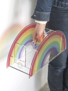 Detail of colorful rainbow acrylic storage rack with a convenient carry handle