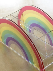 Detailed side view of acrylic rainbow desk organizer with handle and multiple compartments