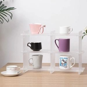 Close-up of three-tier frosted acrylic organizer with modular slot-in structure