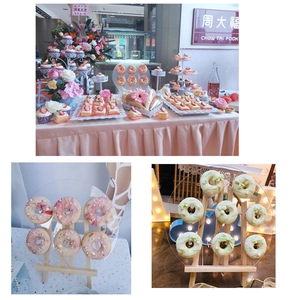 Detail view of the clear acrylic donut display board with a sturdy wooden tripod stand