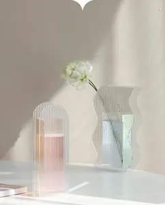Detail of colorful acrylic ripple vases with iridescent finish in modern Nordic style