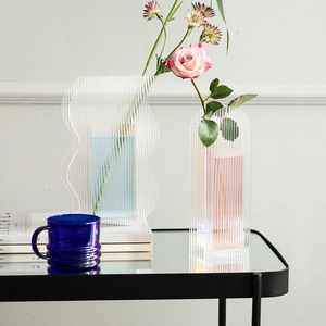 Detailed view of modern acrylic vases with wavy patterns and glacier-like textures