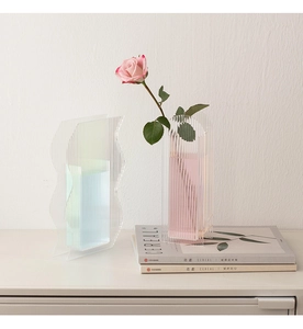 Detail of ripple texture acrylic vases in translucent pink and blue for modern home decor