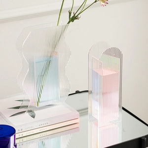 Macro detail of iridescent acrylic vase with vertical wave patterns for home decor