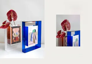 Detail view of colorful geometric acrylic vases with layered design and floral accents