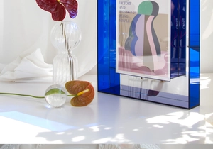 Detail of blue acrylic art frame showing geometric design and light reflection