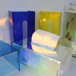 Close-up of colorful acrylic tissue boxes showing blue, yellow, and iridescent textures