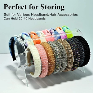 Detailed view of clear acrylic headband display stand holding multiple hair accessories