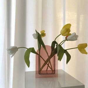 Detailansicht einer rosa Acryl-Bogenvase mit Tulpen im sanften Sonnenlicht