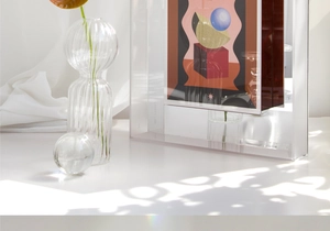 Detail of transparent acrylic frame with abstract geometric art and Lagom Lab engraving