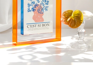 Detail of colorful geometric acrylic frame with abstract floral art on a white surface