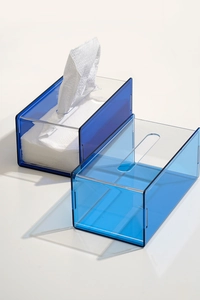 Detail showing two shades of transparent blue acrylic tissue boxes in a minimalist style