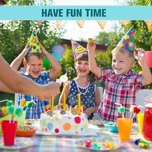 Kids birthday party set with hats, plates, and colorful decorations in outdoor setting