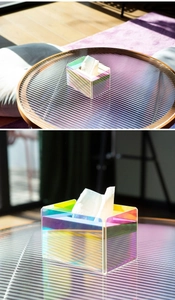 Detail view of iridescent acrylic tissue box with colorful light refraction and texture