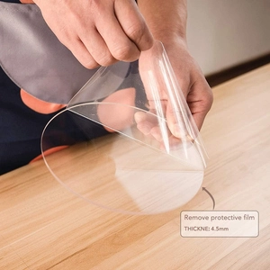 Detail showing removal of protective film from a 4.5mm thick acrylic cake disk