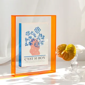 Nordic colorful acrylic art frame with floral card on white table in sunlight