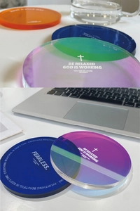 Detail of colorful acrylic coasters with printed motivational quotes in a modern office setup
