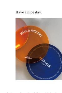 Close-up of colorful acrylic coasters with silk-screened motivational text on a flat surface