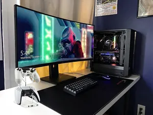 Dual-tier clear acrylic controller stand on a gaming desk with two controllers