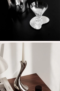 Artistic close-up of heart-shaped acrylic mirror coaster and sleek candle holder
