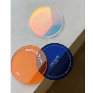 Three colorful acrylic coasters with motivational quotes like HAVE A NICE DAY in Nordic style