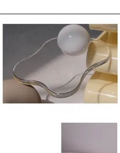 Macro detail of a wavy acrylic display tray with transparent finish for home decor