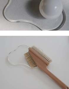 Close-up of dual-sided bristles and natural wood handle of a Nordic style cleaning brush