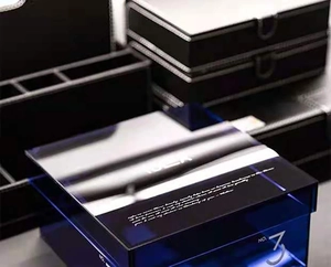 Detail of blue transparent acrylic storage box with NO. 3 logo and decorative mirror lid