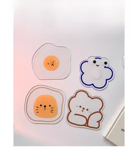 Macro shot of cute acrylic cartoon coasters including egg, flower, and bear designs