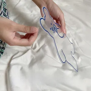 Removing protective film from clear bear shaped acrylic jewelry organizer with blue edges