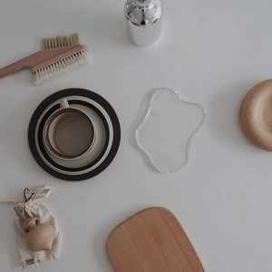 Minimalist acrylic coaster set with modern ceramic coffee cup and wooden decor items