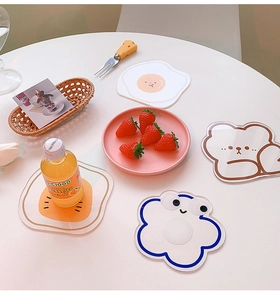 Detailed view of creative acrylic coasters with cute cartoon bear and flower designs