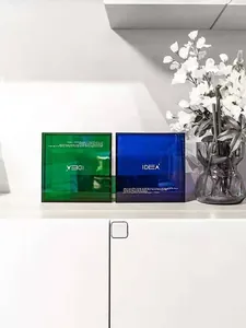 Detail view of emerald green and royal blue acrylic storage boxes with IDEA lettering