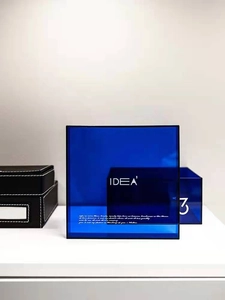 Close-up of blue translucent acrylic storage box featuring elegant white printed typography