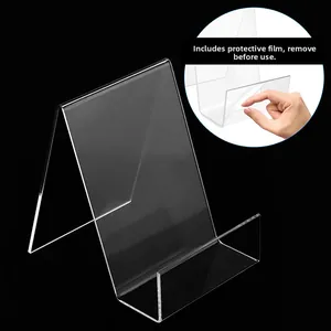 Close-up of clear acrylic book stand detail showing protective film being peeled off