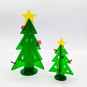 Mini green acrylic Christmas tree set with yellow stars and red ornaments on white background
