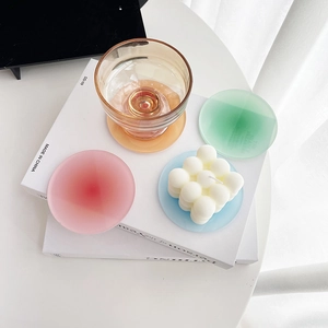 Colorful sunset gradient acrylic coasters set with bubble candle on white books