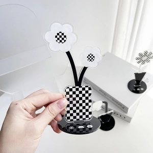 Detail of acrylic flower desk ornament with black and white checkerboard pattern