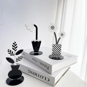 Minimalist black and white acrylic flower desk ornaments with chess pattern base detail