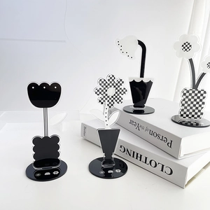 Detailed view of checkered acrylic flower photo clips and desktop memo holders set