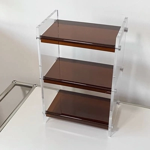 Three-tier acrylic organizer rack with amber shelves and transparent side panels